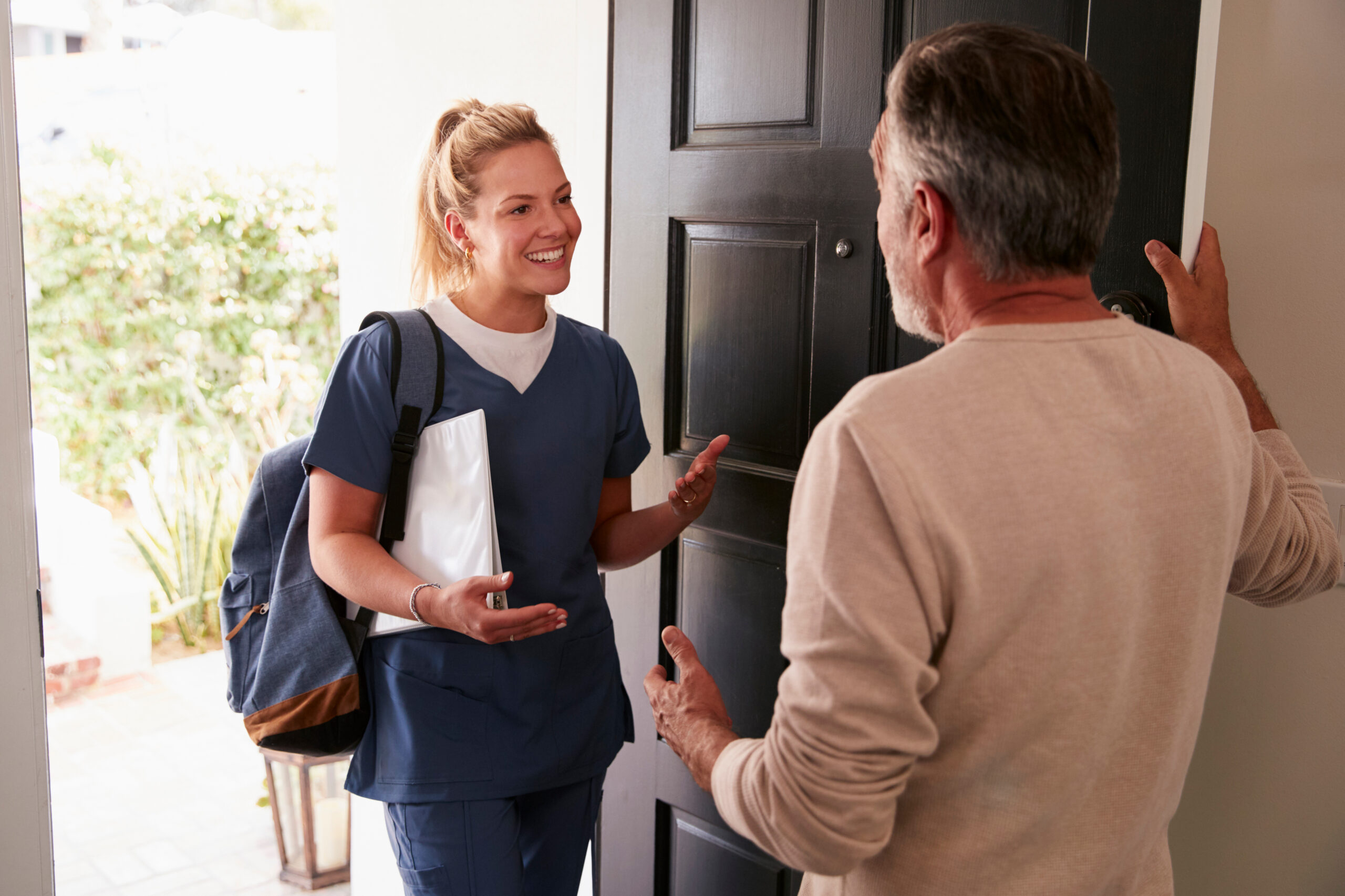 Healthcare worker arriving at a patient's door
