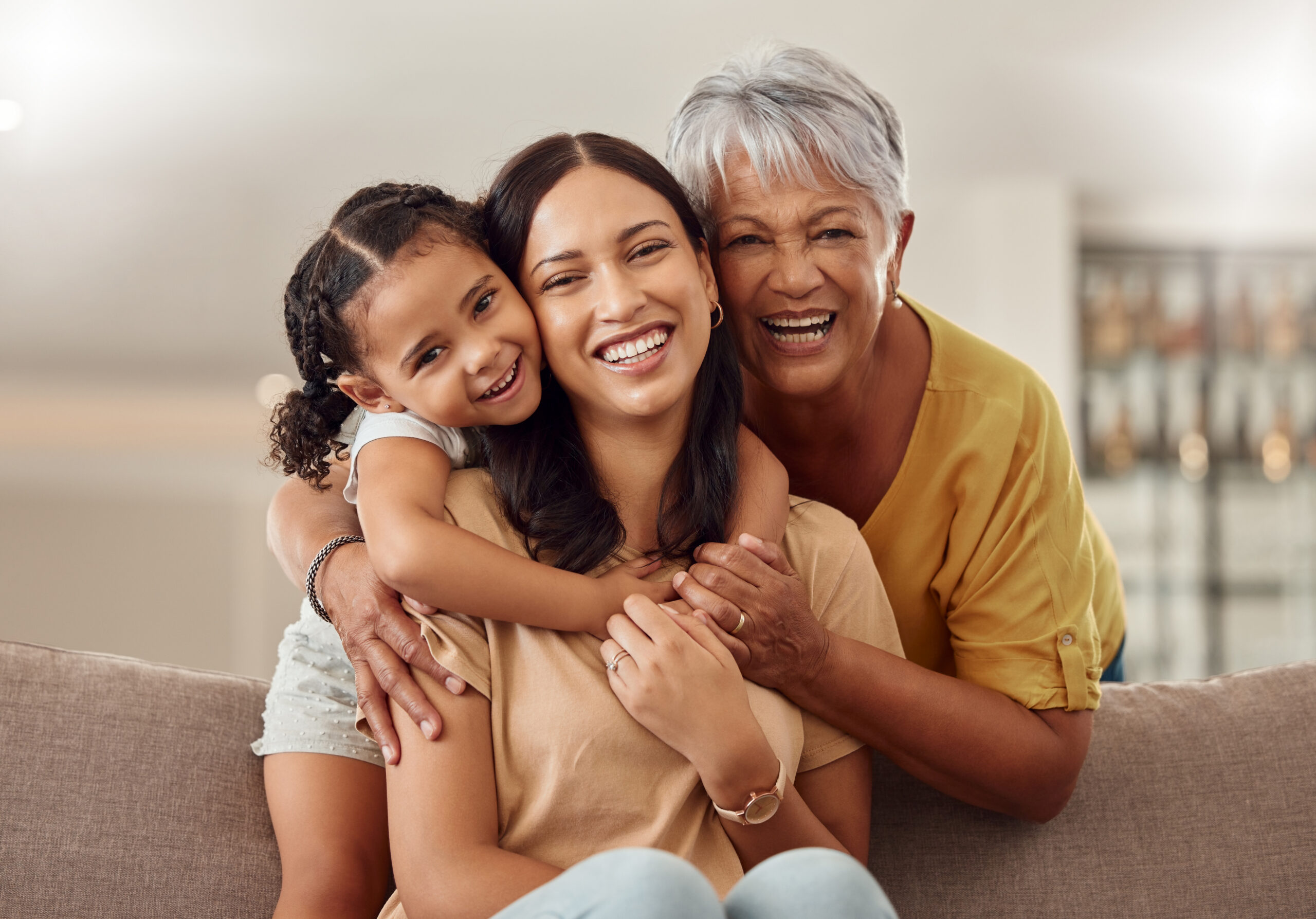 Three generations of women embracing and smiling